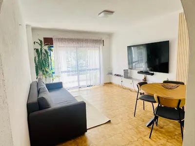 a living room with a couch and a table at Milennium Holiday Apartment in Quarteira