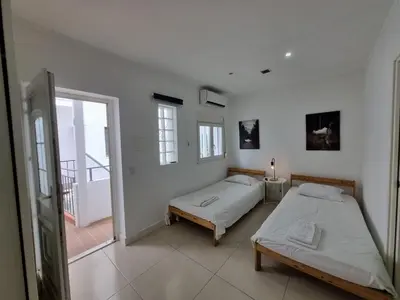 a bedroom with two beds and a balcony at By the Sea Apartments B3 in Albufeira