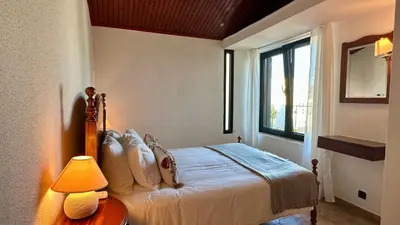 a bedroom with a bed and a table with a lamp at Gemini by Check-in Portugal in Albufeira