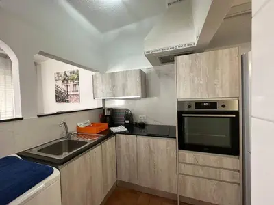 a small kitchen with a sink and a microwave at White House By FHR in Quarteira