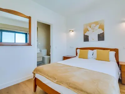 a bedroom with a bed and a window at Casa Barakat with Pool and BBQ in Vale do Lobo in Quinta do Lago