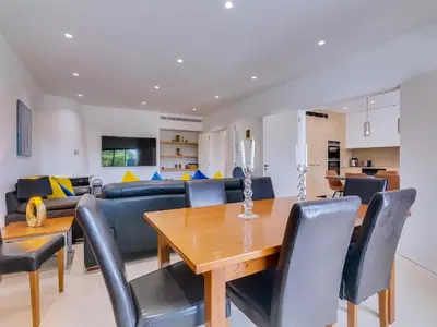 a kitchen with a dining room table and chairs at Casa Barakat with Pool and BBQ in Vale do Lobo in Quinta do Lago