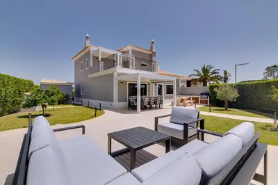 a villa with a view of the patio and backyard at Casa Barakat with Pool and BBQ in Vale do Lobo in Quinta do Lago