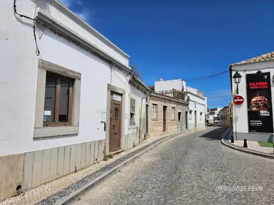 an empty street in a town with white buildings at Blife Castelya private property in Faro