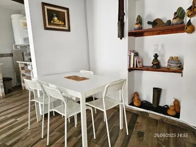 a white table and chairs in a room at Blife Castelya private property in Faro