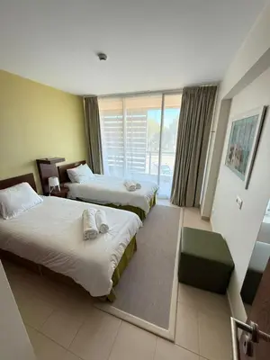 a hotel room with two beds and a window at Herdade dos Salgados in Guia
