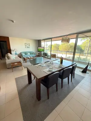 a dining room with a table and chairs in a living room at Herdade dos Salgados in Guia