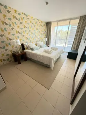 a bedroom with a bed and a large window at Herdade dos Salgados in Guia