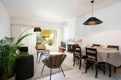 a living room with a dining room table and chairs at Bmyguest - Vale do Lobo Family Beach Villa in Vale do Lobo