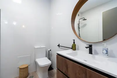 a bathroom with a white toilet and a mirror at Bmyguest - Vale do Lobo Family Beach Villa in Vale do Lobo