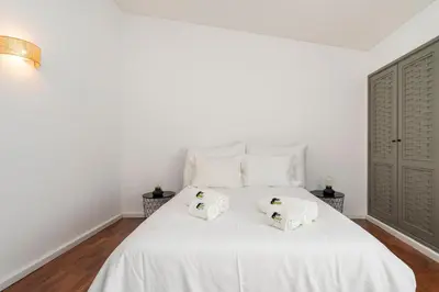 a bedroom with a white bed with towels on it at Bmyguest - Vale do Lobo Family Beach Villa in Vale do Lobo