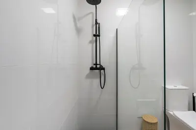 a bathroom with a shower with a glass door at Bmyguest - Vale do Lobo Family Beach Villa in Vale do Lobo