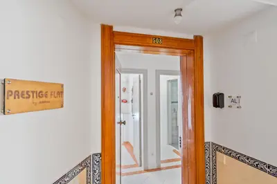 a door in a room with a sign on the wall at Prestige Flat by Albufeira Holidays in Albufeira