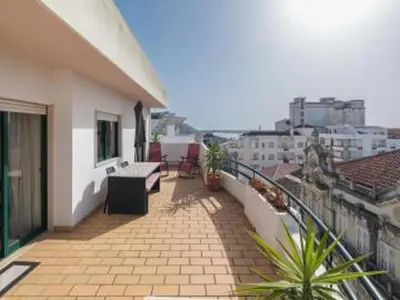 a balcony of a building with a view of a city at Faro Charm Apartment - City Center in Faro
