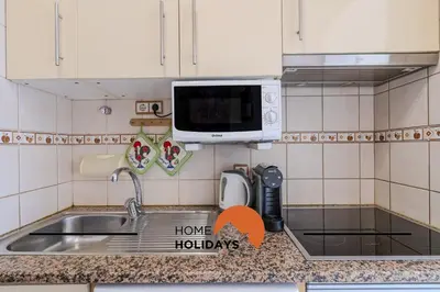 a kitchen counter with a sink and a microwave at #324 Ribeira Park by Home Holidays in Albufeira