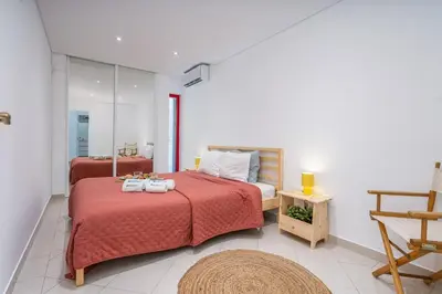 a bedroom with two beds and a mirror at HostWise - Sunny Escape with a Pool & Balcony in Vilamoura