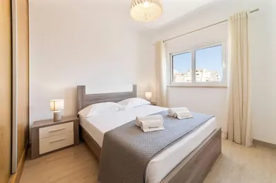 a bedroom with a bed and a window at Golden View Villa by HelloVacations in Albufeira