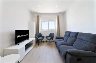 a living room with a blue couch and two chairs at Golden View Villa by HelloVacations in Albufeira