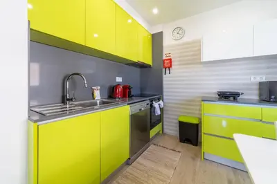 a kitchen with bright yellow cabinets and a sink at Golden View Villa by HelloVacations in Albufeira
