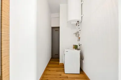 a hallway with a refrigerator in a white room at Sea Side in Albufeira
