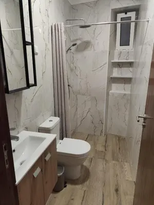 a white bathroom with a toilet and a sink at Simply House in Faro