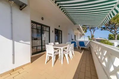 a patio with a table and chairs on a balcony at Tangerine Apartment by HelloVacations in Albufeira