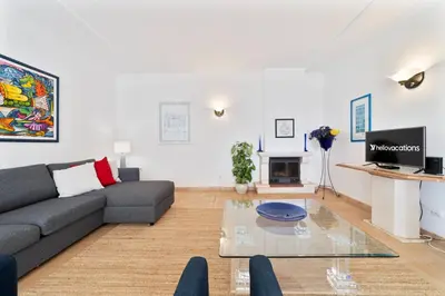 a living room with a couch and a table at Tangerine Apartment by HelloVacations in Albufeira