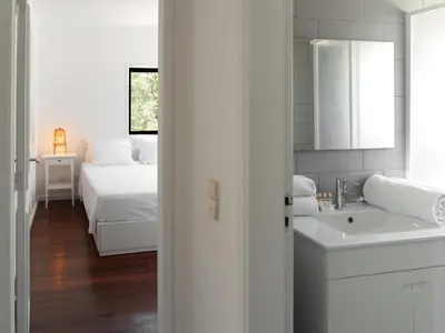 a white bathroom with a bed and a sink at Delta Marina in Vilamoura