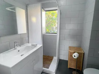 a white bathroom with a sink and a shower at Delta Marina in Vilamoura