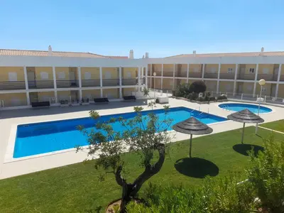 a hotel with a swimming pool and a courtyard at Encosta Sao Jose - Apartment V in Albufeira