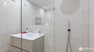 a white bathroom with a sink and a shower at Apartamento Fairway in Loulé