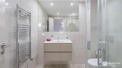 a white bathroom with a sink and a shower at Apartamento Fairway in Loulé