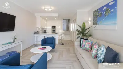 a living room with a couch and a table at Apartamento Fairway in Loulé