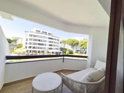 a room with a balcony with a table and chairs at Vilamoura Collection in Quarteira