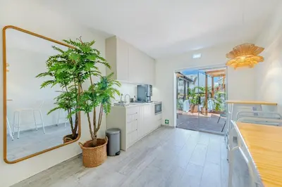 a kitchen with a potted tree in the middle of it at The 23 Suites in Faro