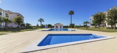 a swimming pool in the middle of a yard at Beach Apartment Vilamoura Villa Columbus in Vilamoura