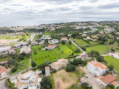 a villa with a swimming pool and a guest house at Casa Gralheira - Private Pool & Sea View in Albufeira