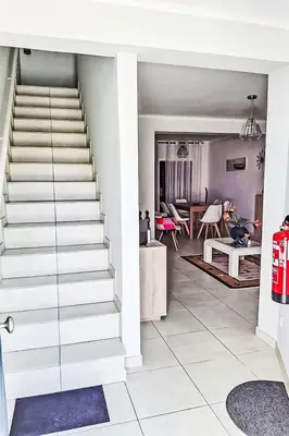 a staircase leading to a living room and a dining room at Holiday Home Villa Medusa by Interhome in Vilamoura