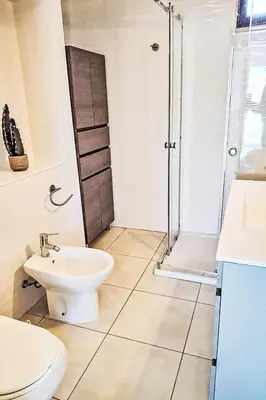 a bathroom with a shower and a toilet and a sink at Holiday Home Villa Medusa by Interhome in Vilamoura