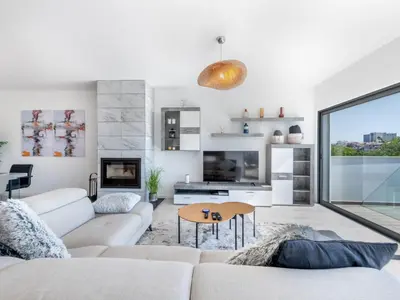 a dining room and living room with a table and chairs at Villa Linda V3 Lote 67 - VIP Properties by Interhome in Albufeira