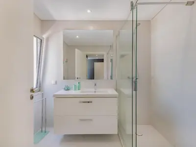 a bedroom with two beds and a chair and a mirror at Holiday Home Miguel VIP Properties by Interhome in Albufeira