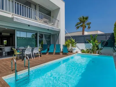 a bedroom with a bed and a window and a chair at Holiday Home Miguel VIP Properties by Interhome in Albufeira