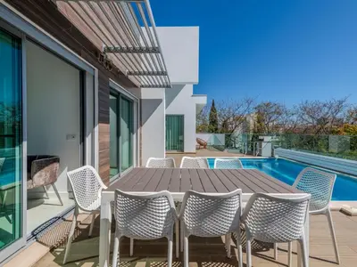 a patio with white chairs and tables on a roof at Villa Vitória V3 Lote 68 - VIP Properties by Interhome in Albufeira