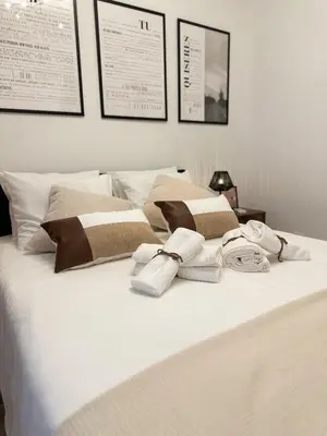 a white bed with towels and pillows on it at Casa Rústica em Loulé - Karmea's Houses in Loulé
