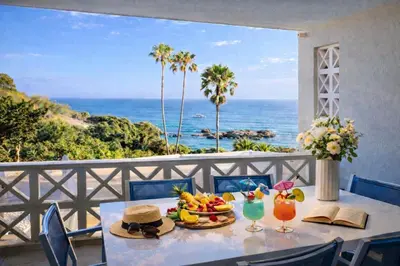 a table with a plate of food and a view of the ocean at Ocean Bliss II- Panoramic Sea View - 20m to Beach - 2 Swimming Pools - Private Parking in Albufeira