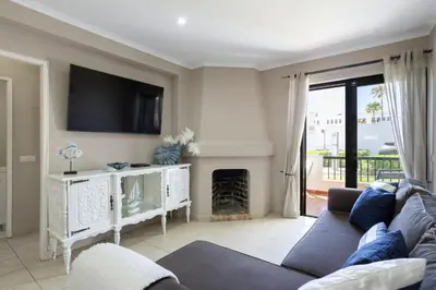 a living room with a couch and a fireplace at Forte Beach Retreat - 2BR Apartment with Terrace & AC in Caliços
