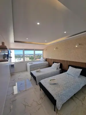 three beds in a room with white walls and windows at LuxPool Albufeira Stay in Albufeira
