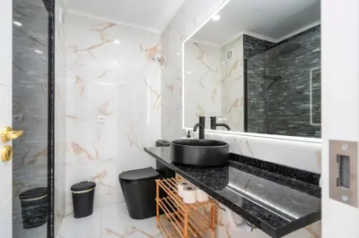 a bathroom with a sink and a shower at LuxPool Albufeira Stay in Albufeira
