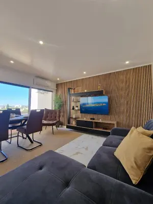 a kitchen with a black sink and a tv at LuxPool Albufeira Stay in Albufeira