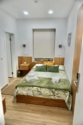 a bedroom with a large bed with two towels on it at Casa Tapada do Bento II- Albufeira in Albufeira